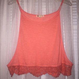Pink tank top with lace like detailing in bottom